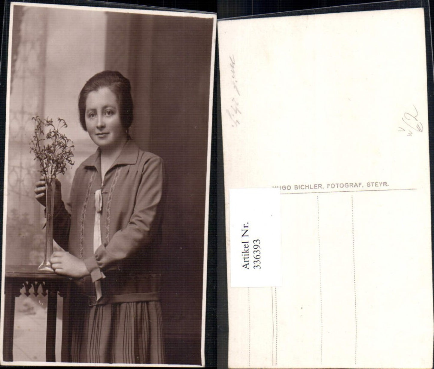 336393, Photo Ak Woman standing by table vase flowers pub Hugo Bichler Steyr