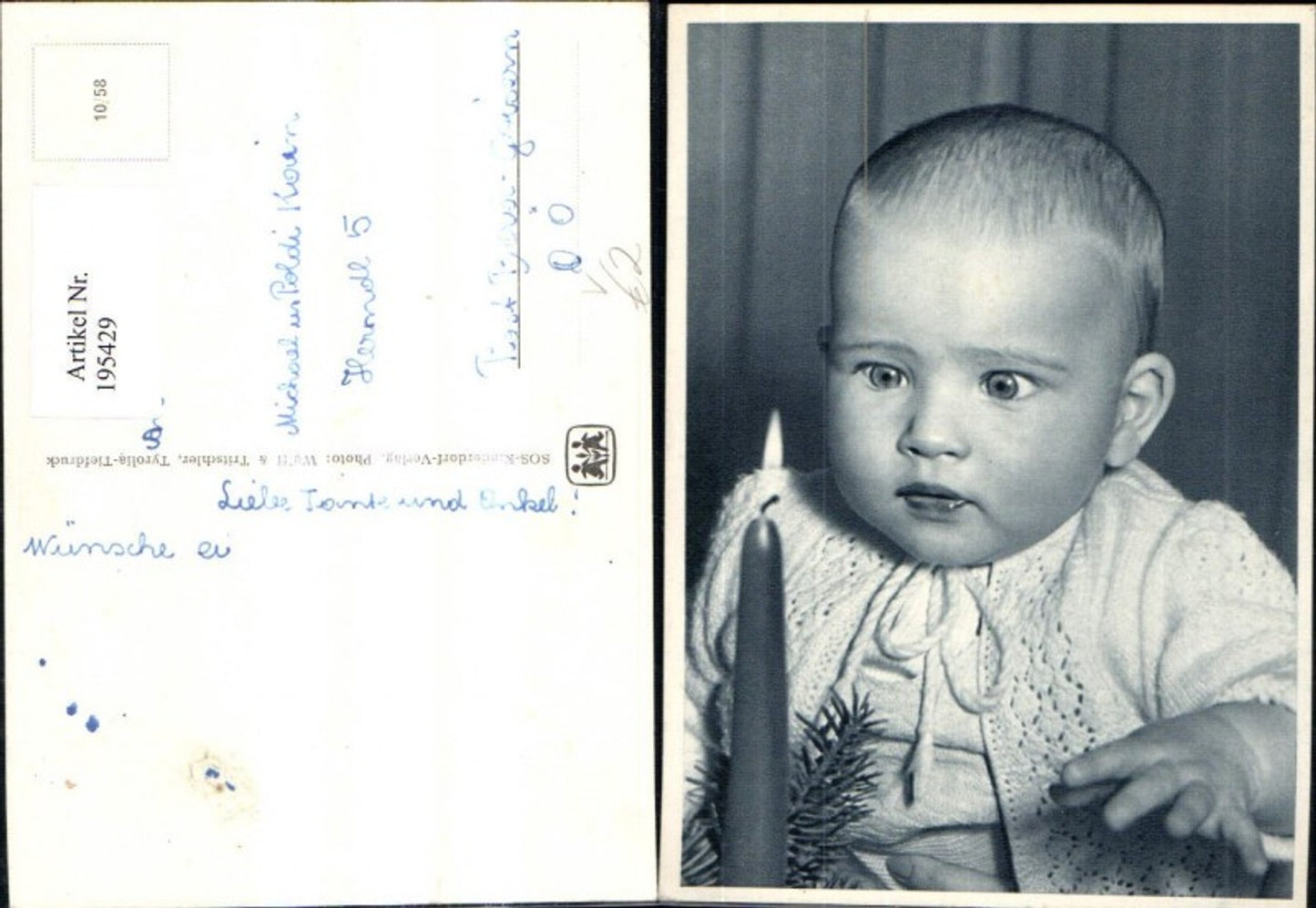 195429, SOS Children's Village 10/58 Child with big eyes sitting by a candle