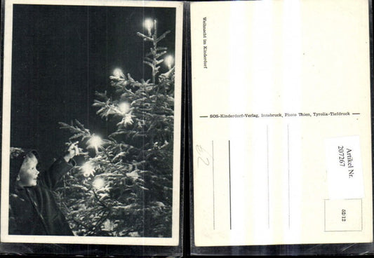 207267, SOS Children's Village 52/12 Christmas in Children's Village Child by Christmas tree with snow and candles