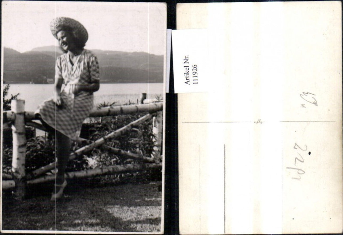 111926, Photo Ak Woman with hat straw hat sitting by fence