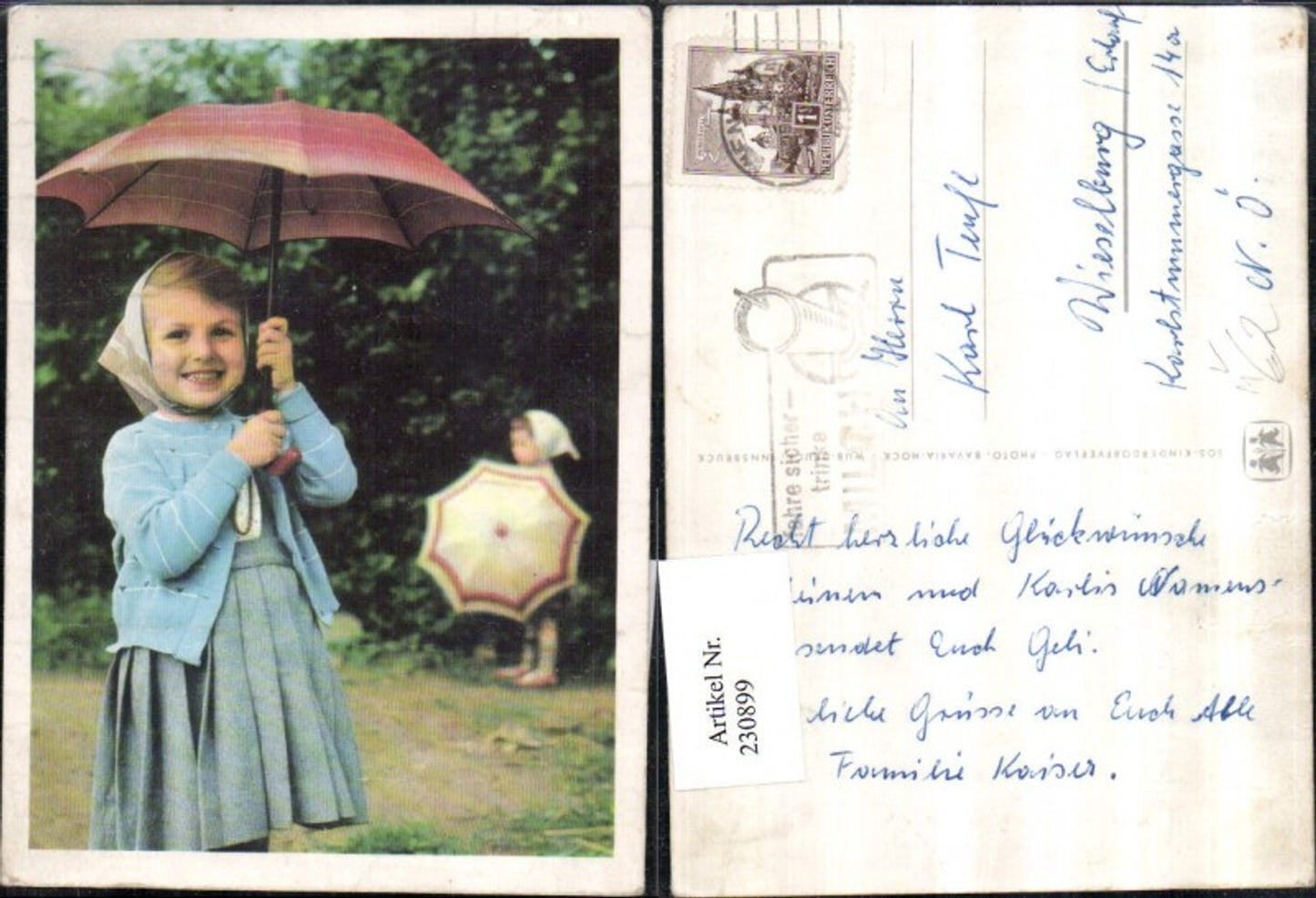 230899, SOS Children's Village girl with dress, vest, headscarf, and umbrella