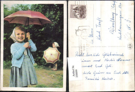 230899, SOS Children's Village girl with dress, vest, headscarf, and umbrella