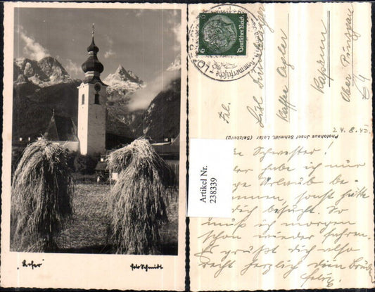 238339,Lofer Kirche Heuhaufen Bergkulisse