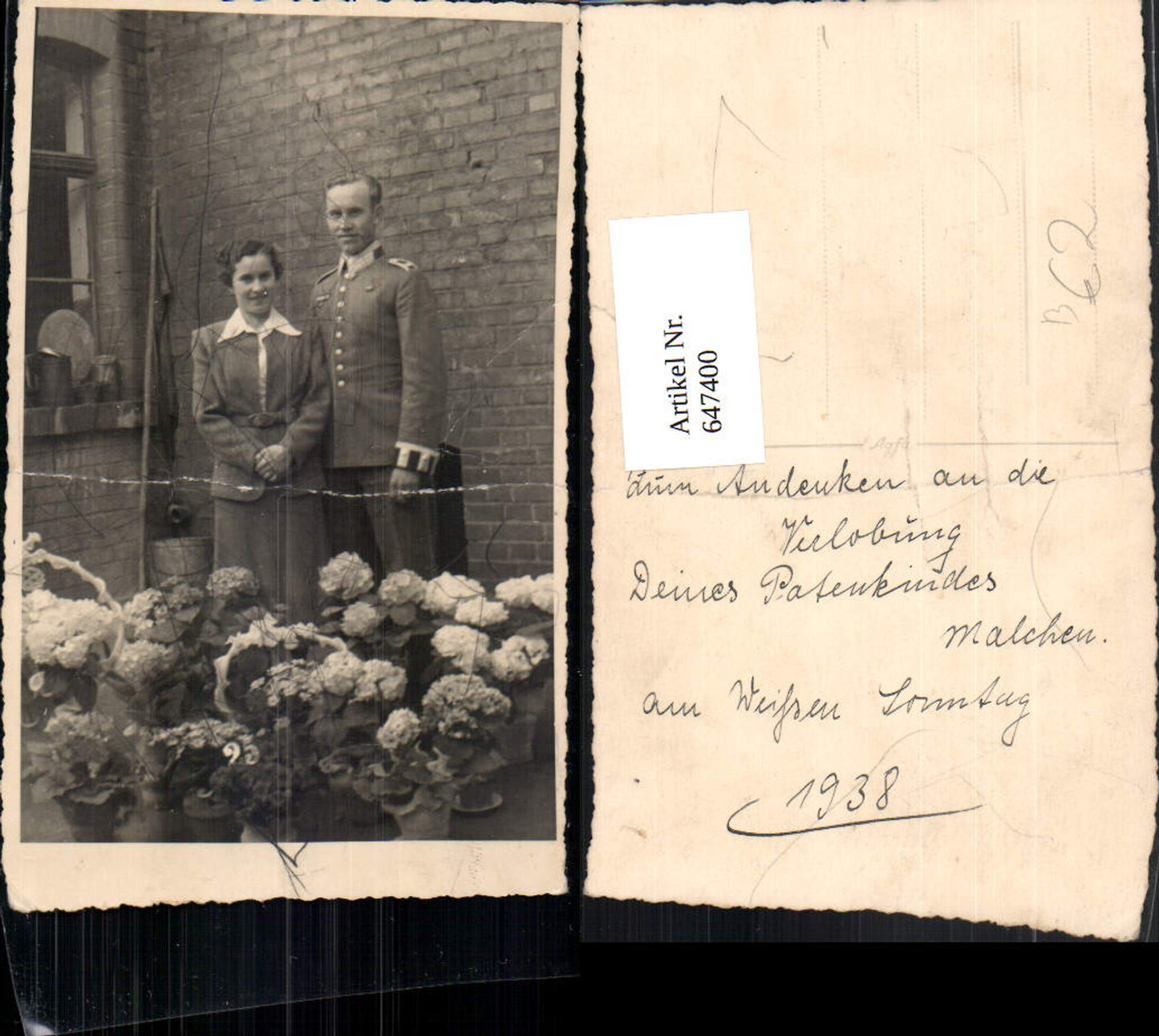 647400, Photographic art: Couple in suit, man in uniform, flowers, standing in front of house, engagement